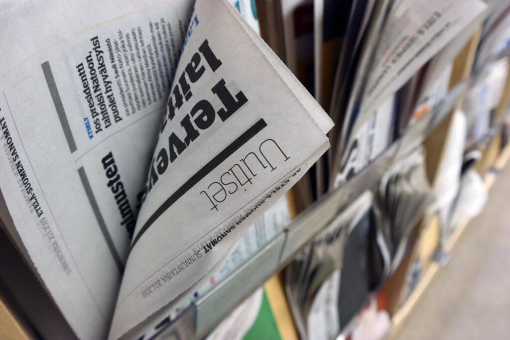 The photo shows newspapers in the library's newsroom