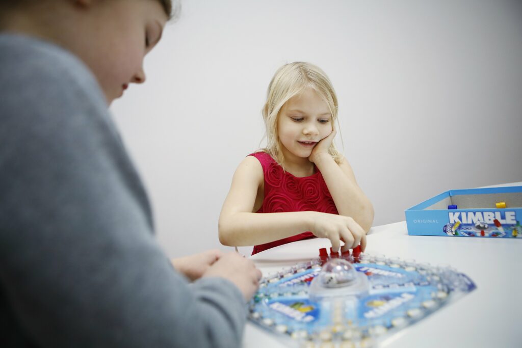 A child plays a dice game in preschool.