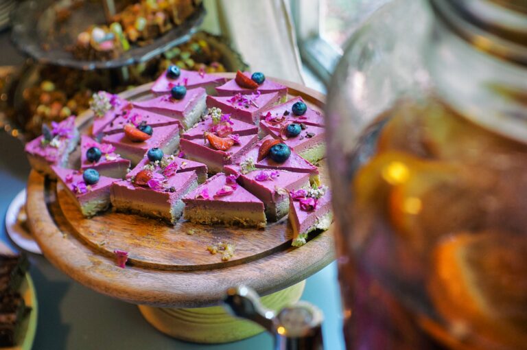 Light red raw cake pieces on a tray.