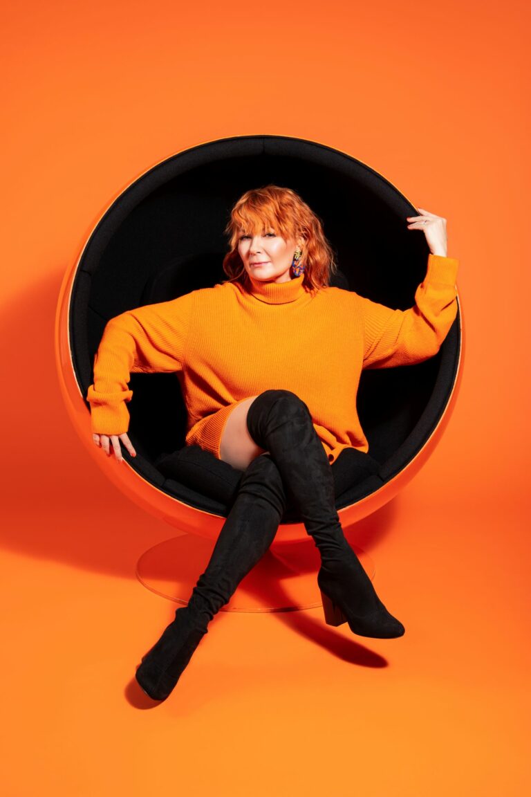 Singer Irina is sitting in a ball chair.