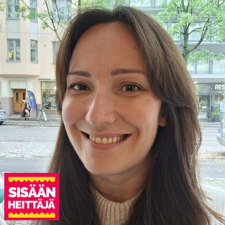 A smiling long-haired person in the foreground, the stone base of an old apartment building in the background. In the lower left corner, a red-yellow graphic logo with the words Sisäänheittäjä