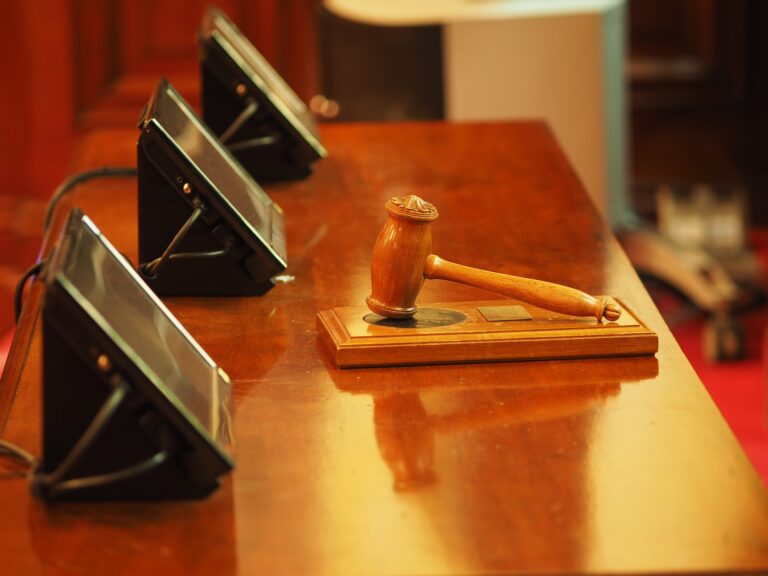 Chairman's gavel on polished mahogany table.