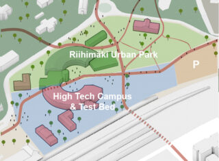 Havainnekuva maa-alueesta, jossa keskellä kaksi puolikaaren muotoista rakennusta vierekkäin. Toinen osa puolikaaresta on nimetty High Tech Campus and Test Bed. Toinen puolikaari on nimetty Riihimäki Urban Park. Harmaa rautatien merkintä kulkee puolikaarien edessä. 